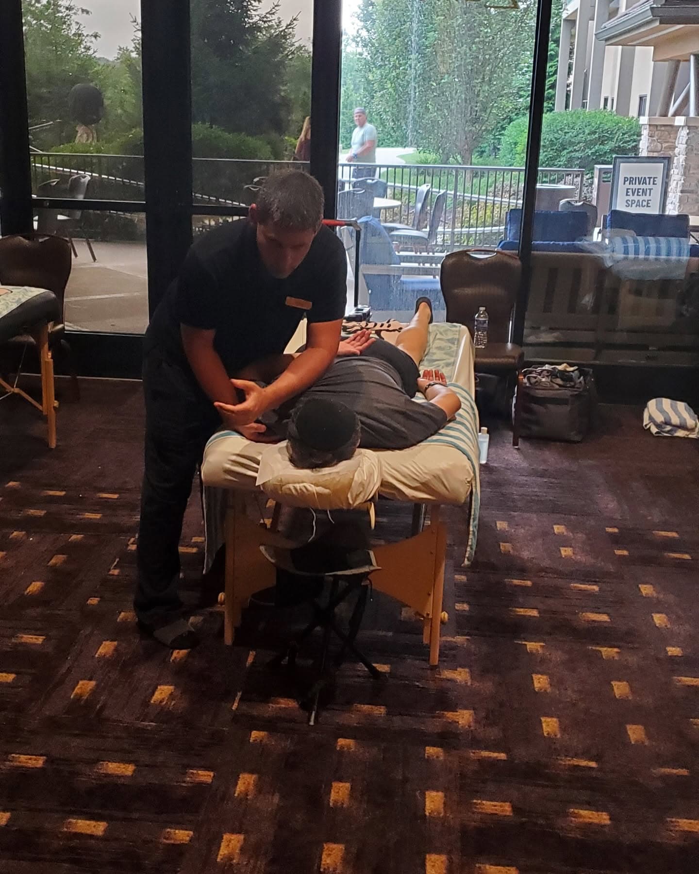Douglas providing massage therapy at an event